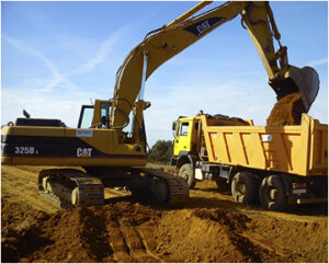 Retroexcavadora CAT de excavaciones Félix López transfiriendo tierra a camión en obra civil. Esta imagen subraya la eficacia con la que excavaciones Félix López realiza trabajos de excavación, transporte y gestión de tierras, aportando soluciones integrales en Salamanca y Castilla y León.
